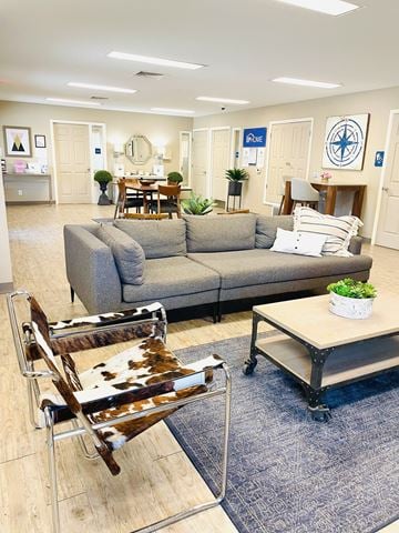 El Paso apartment for rent - A living room with a grey couch and a cowhide chair.
