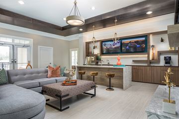 Ladson apartment for rent - A modern living room with a grey sofa and a patterned coffee table.