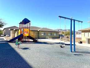 El Paso apartment for rent - A playground with a blue swing set and a yellow slide.