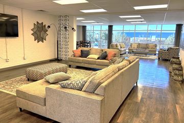 El Paso apartment for rent - A living room with a large sectional sofa and a flat screen TV mounted on the wall.