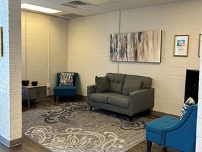 El Paso apartment for rent - A living room with a grey couch and a blue chair.