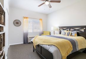 El Paso apartment for rent - A bedroom with a bed, pillows, and a ceiling fan.