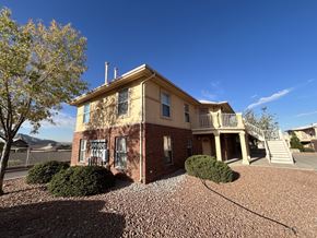 El Paso apartment for rent - A house with a gravel driveway and a tree in front.