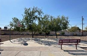 El Paso apartment for rent - A basketball court with a red bench and a basketball hoop.