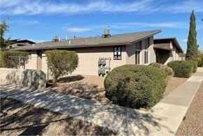 El Paso apartment for rent - A house with a driveway and a tree in front.
