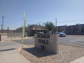 El Paso apartment for rent - A sign for Weber Trails 110 is in front of a building.