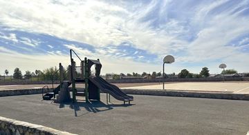 El Paso apartment for rent - A playground with a slide and a basketball court.