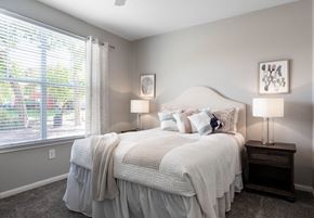 El Paso apartment for rent - A bedroom with a large bed and a window with blinds.