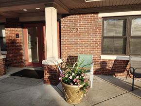 Louisville apartment for rent - a planter with flowers in front of a brick building