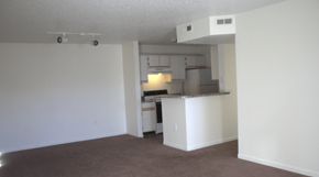 Peoria apartment for rent - an empty living room with a kitchen in it