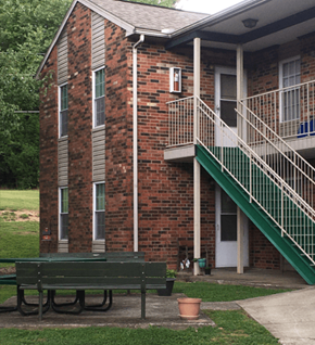 Greenville apartment for rent - a bench in front of a building with stairs