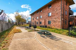 Louisville apartment for rent - a picnic area in front of a brick building