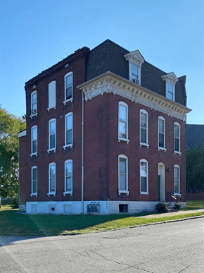 St. Louis apartment for rent - A red brick building with white trim and a black roof.