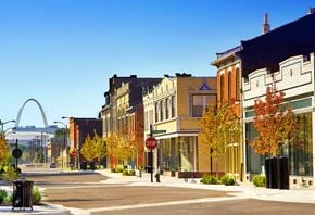 St. Louis apartment for rent - A city street with a stop sign and a large arch in the background.