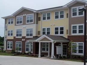 St. Louis apartment for rent - A two-story building with a front porch and multiple windows.