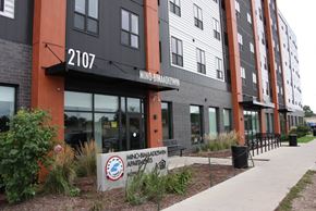 Minneapolis apartment for rent - a building with a sidewalk and a sign in front of it