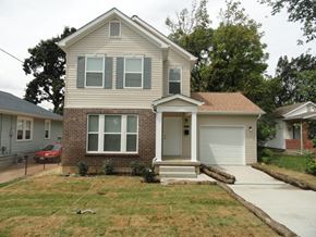 St. Louis apartment for rent - A house with a grey roof and a white garage door.