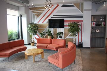 Minneapolis apartment for rent - A living room with a striped wall and a television.