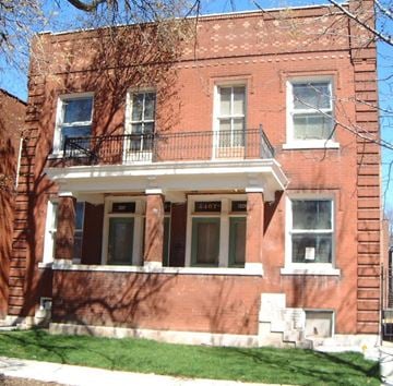St. Louis apartment for rent - A red brick building with a balcony on the second floor.
