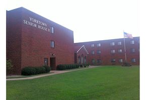 Louisville apartment for rent - a large brick building with an flag in front of it