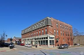 St. Louis apartment for rent - A red brick building with a white trimmed porch and a white awning with the word "HOTEL" on it.