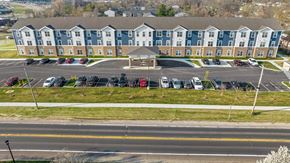 St. Louis apartment for rent - a parking lot with cars in front of an apartment building
