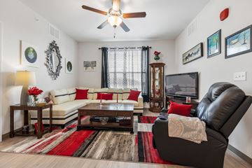 St. Louis apartment for rent - A living room with a black leather chair and a white sofa.