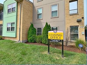 St. Louis apartment for rent - A leasing office sign is posted in front of a building.