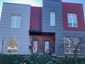 St. Louis apartment for rent - A modern house with a grey, red and blue exterior.