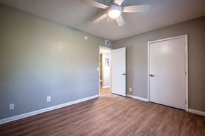 Jacksonville apartment for rent - A room with a ceiling fan and two doors.
