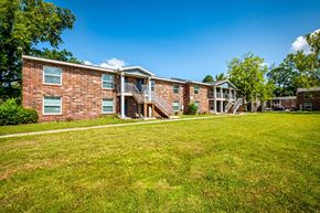Jacksonville apartment for rent - A brick apartment building with a green lawn in front.