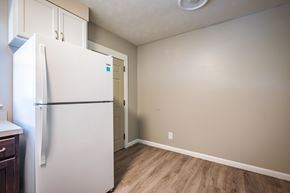 Jacksonville apartment for rent - A white refrigerator in a kitchen with wood flooring.