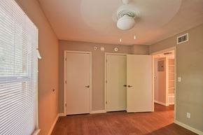 Jacksonville apartment for rent - A room with a white ceiling fan and three white doors.