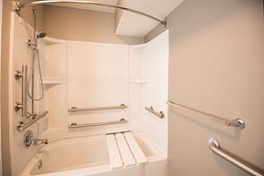Jacksonville apartment for rent - A white bathroom with a tub and shower.