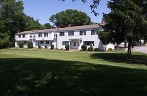 Rock Island apartment for rent - A white house with a green lawn in front.