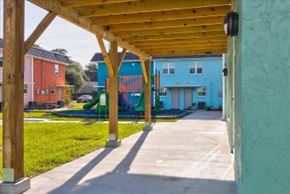 Jacksonville apartment for rent - A playground area with a wooden pergola and a slide in the background.