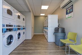 Jacksonville apartment for rent - A laundromat with washers and dryers and a yellow chair.