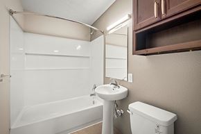 Jacksonville apartment for rent - A white sink is next to a white toilet in a bathroom.
