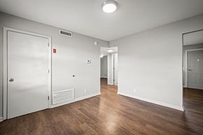 Jacksonville apartment for rent - A room with a white door and a white wall with a mirror on the wall.