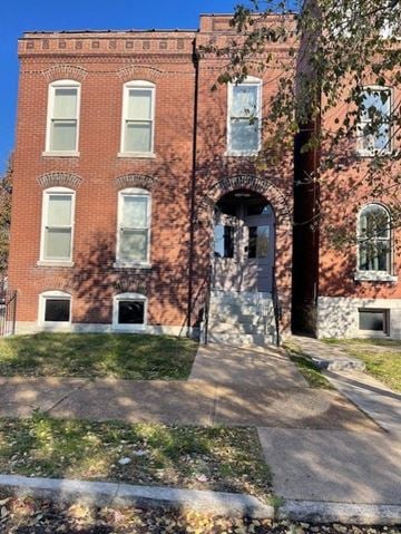 St. Louis apartment for rent - A red brick building with a white door and windows.