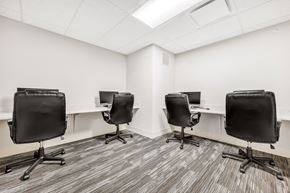 St. Louis apartment for rent - a room with four desks and leather chairs