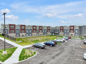 St. Louis apartment for rent - an exterior view of an apartment complex with cars in a parking lot