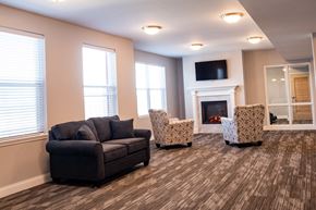 St. Louis apartment for rent - a living room with couches and chairs and a fireplace