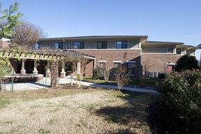 Louisville apartment for rent - a brick house with a patio in front of it