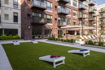 Amenity deck w/ outdoor kitchen, fire pits, activity lawn, pool & hot tub