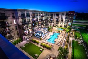 St Louis Park apartment for rent - an overhead view of an apartment complex with a pool at night