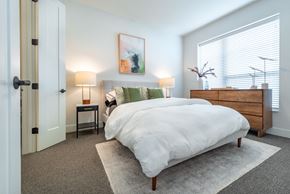 Edina apartment for rent - a bedroom with a bed and a dresser and a window