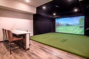 Lakeville apartment for rent - a game room with a projector screen and a table and chairs