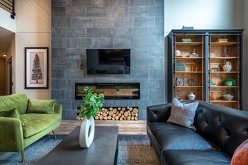 Lakeville apartment for rent - a living room with black leather furniture and a fireplace