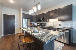Lakeville apartment for rent - a kitchen with stainless steel appliances and a marble counter top